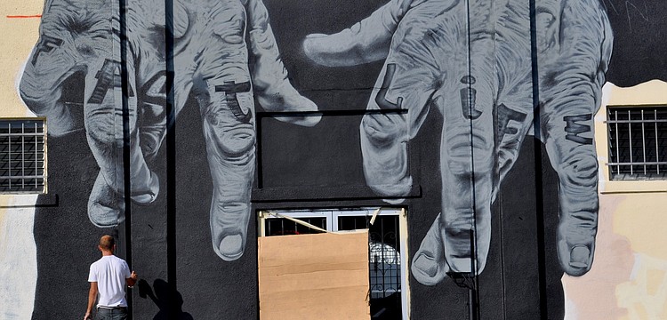 Tube Dude owner Scott Gerber could not be reached to comment on the pair of giant hands that are being spray painted on the exterior of the building.