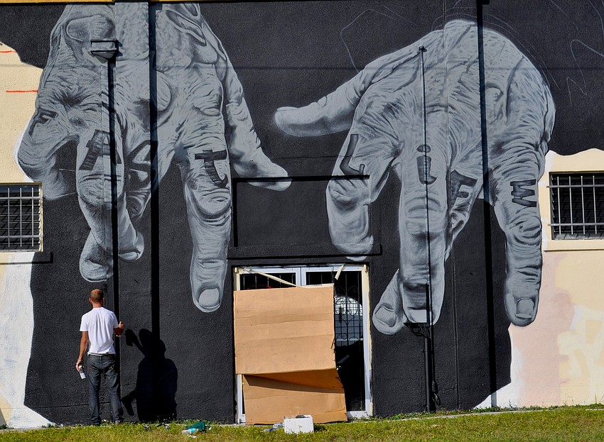 Tube Dude owner Scott Gerber could not be reached to comment on the pair of giant hands that are being spray painted on the exterior of the building.