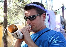 Jason Moore tries to blow through the bull horn, but fails during his attempt. Photo by Rachel S O'Hara.