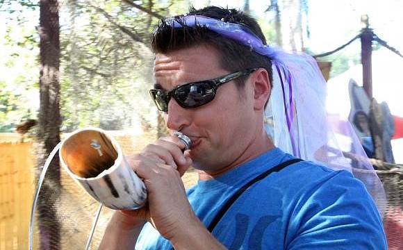 Jason Moore tries to blow through the bull horn, but fails during his attempt. Photo by Rachel S O'Hara.