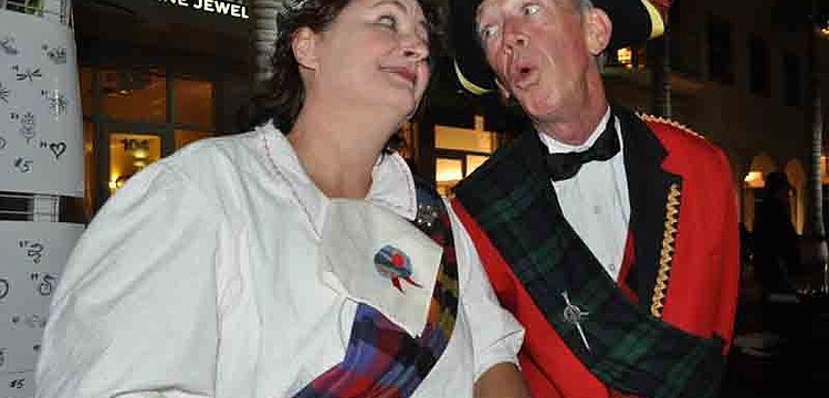 Karen Bell enjoyed a song by Robin Eurich as she made balloon animals for guests.