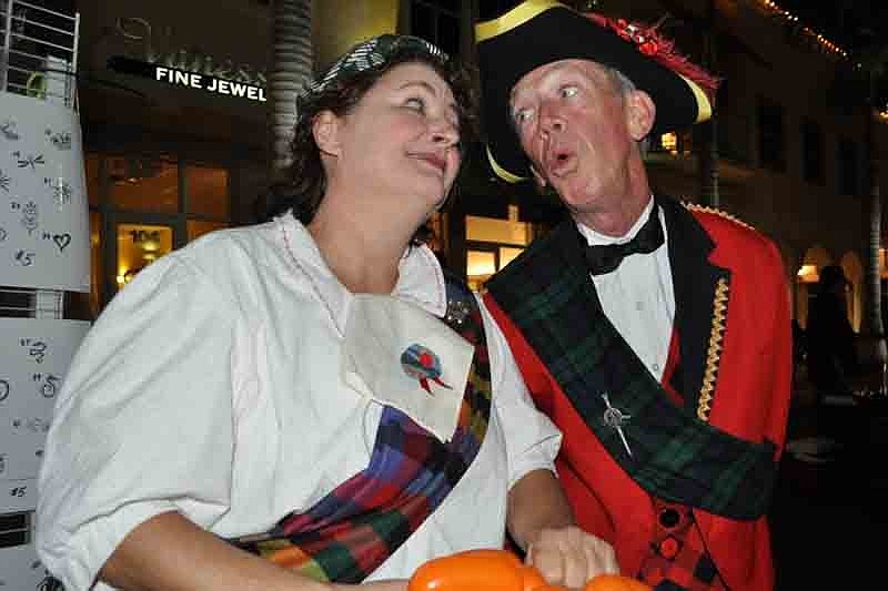 Karen Bell enjoyed a song by Robin Eurich as she made balloon animals for guests.