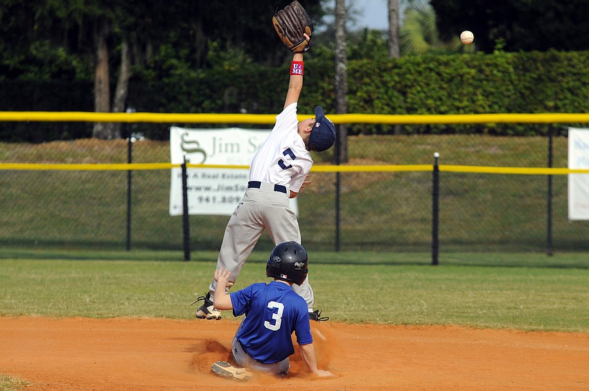 Logan Grace, 7, slides safely into second base as the throw sails over the head of the Rays second baseman.