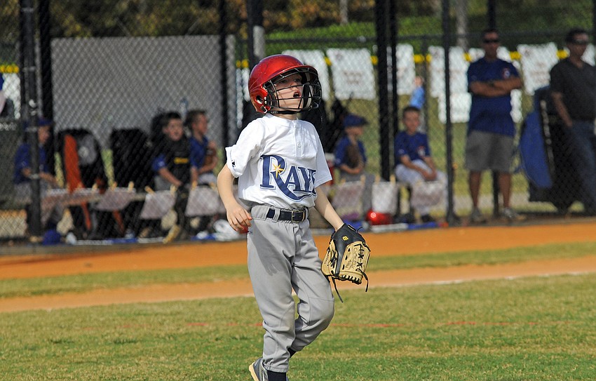 Nine-year-old Clayton Avins looks back toward first base to see if his teammates got the out.
