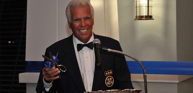 Commodore Bob Baime prepares to cut the ribbon