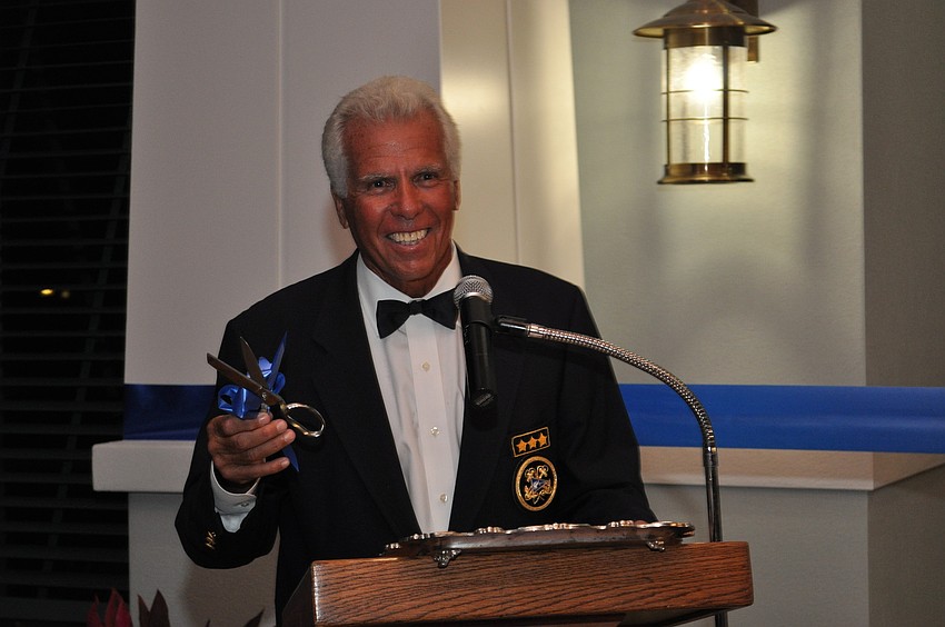 Commodore Bob Baime prepares to cut the ribbon