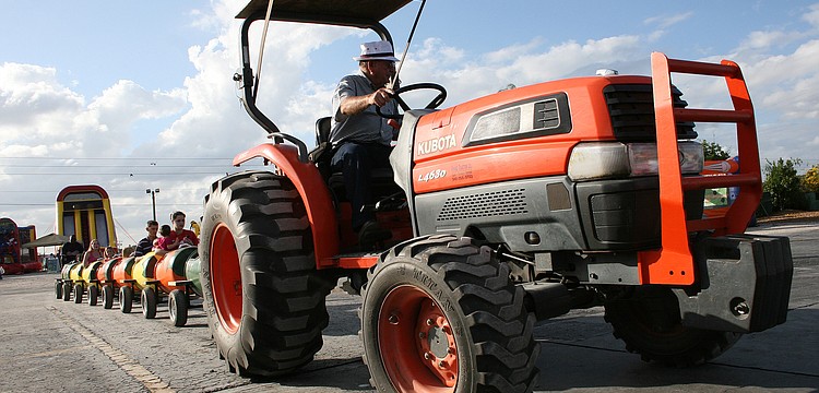 Children enjoyed a tractor-pulled train ride through the groves.
