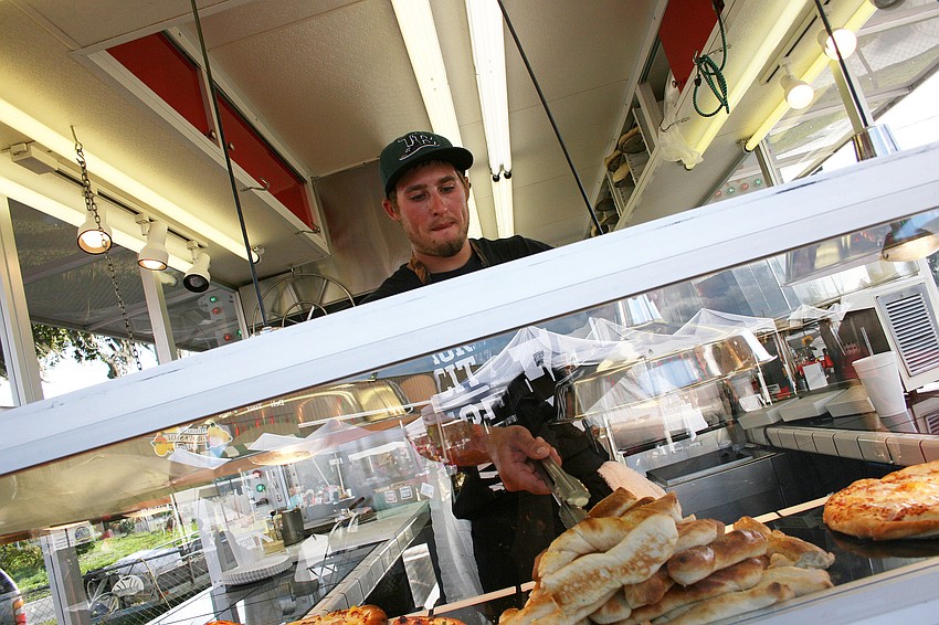 Brett Bosier served up pizza and other treats at this yearâ€™s Harvest Festival.