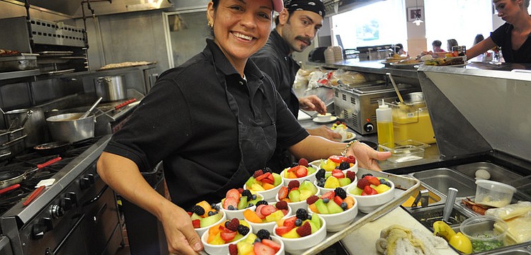 Olga Fuentes prepares fruit bowls at Station 400, an eatery that opened Nov. 26 on Lakewood Ranch Main Street.