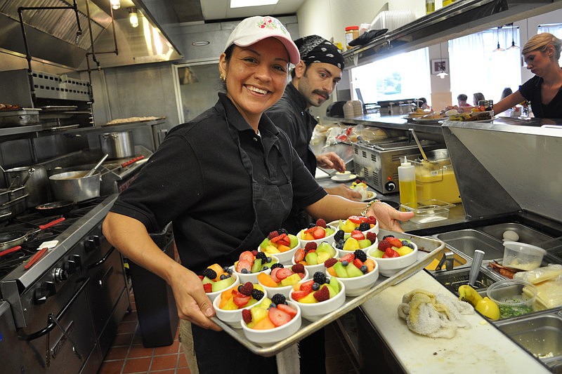 Olga Fuentes prepares fruit bowls at Station 400, an eatery that opened Nov. 26 on Lakewood Ranch Main Street.