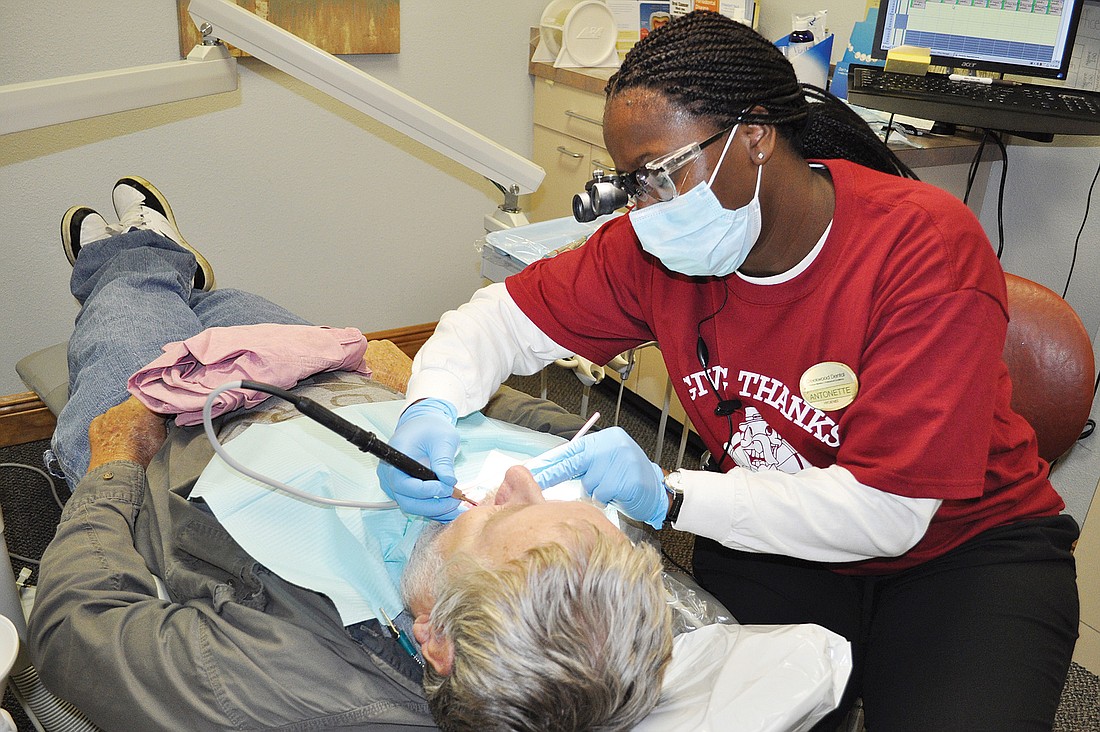 Glenn Rider gets his teeth cleaned by Creekwood DentalÃ¢â‚¬â„¢s Antonette Preston-Thomas.