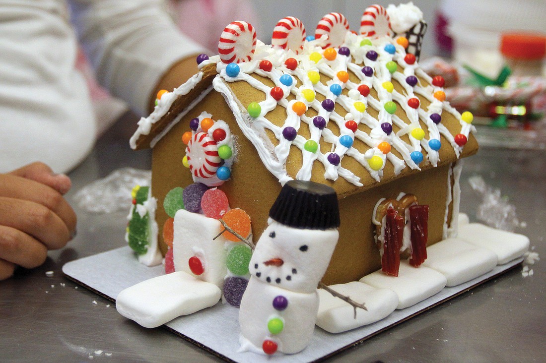The gingerbread house created by Girls Inc. for the CYD competition included a marshmallow snowman, pretzel windows and a decorated rooftop with a chimney.