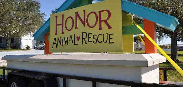 Workers from Florida Sign Co. today are busy erecting a new monument sign for Honor Animal Rescue at its Lorraine Road ranch.