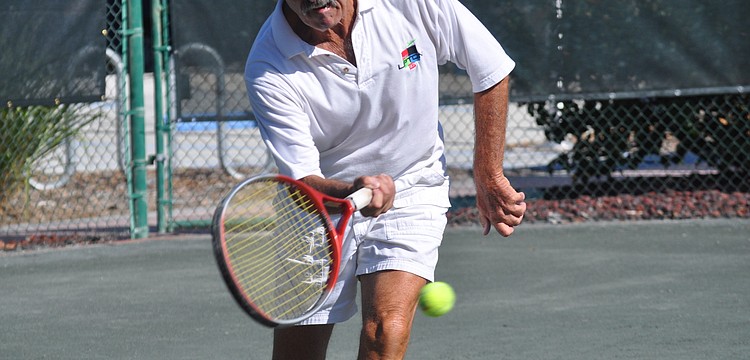 Joe Pundt volleys an incoming ball. Pundt played against Jim Baker in the Senior Clay Courts - CAT II at Longboat Key Public Tennis Center.