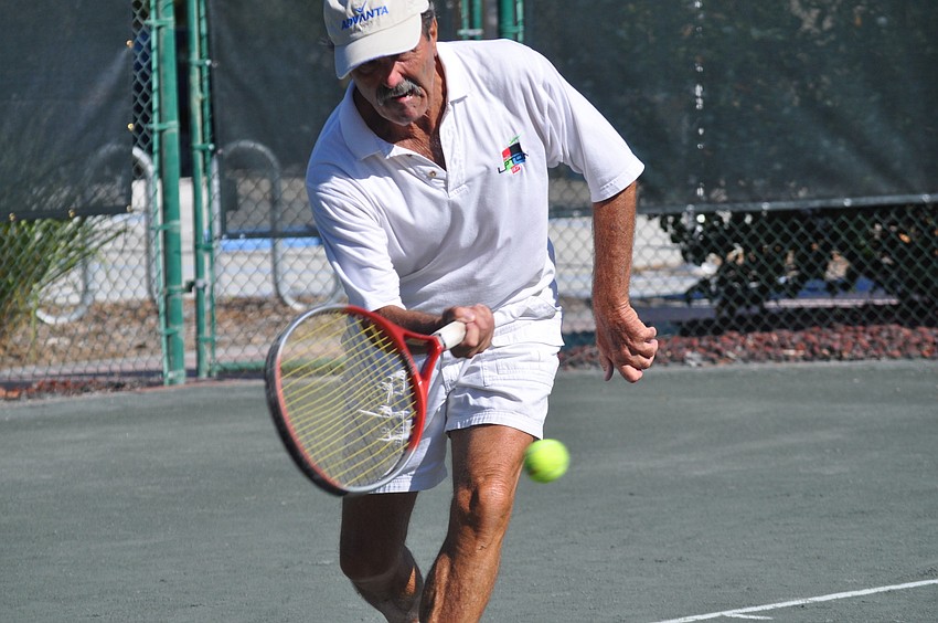 Joe Pundt volleys an incoming ball. Pundt played against Jim Baker in the Senior Clay Courts - CAT II at Longboat Key Public Tennis Center.
