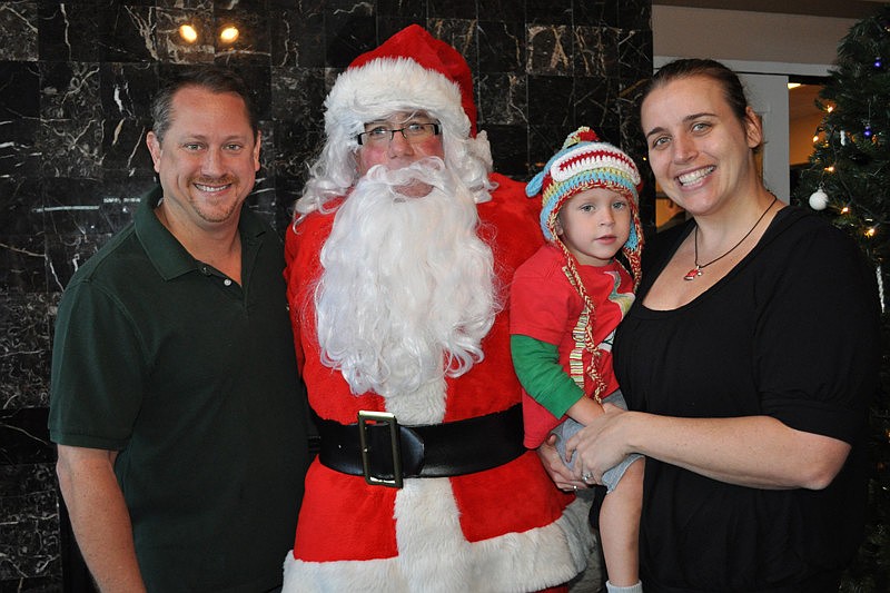 Michael Schaunnault and his son, Alexander, and wife, Samantha, couldnâ€™t resist a photo with Santa, portrayed by Jeff Spencer.