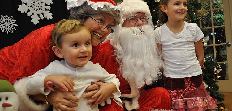 Mason and Neenah Fuste made sure to get their picture taken with Mr. and Mrs. Claus, played by Jeanne and John Larranaga.