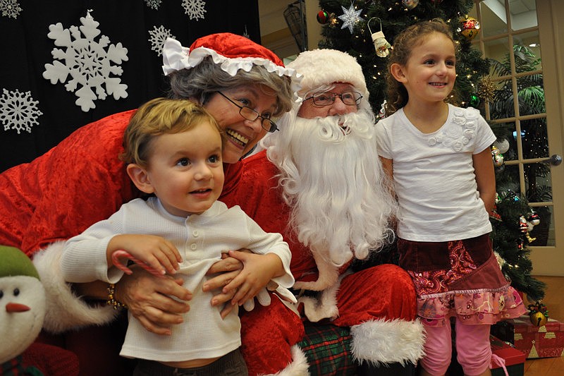 Mason and Neenah Fuste made sure to get their picture taken with Mr. and Mrs. Claus, played by Jeanne and John Larranaga.