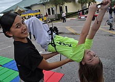 Lakewood Ranch High School JROTC student Sarely Gutierrez helped Kristina Tripoli, 9, with a rope challenge.