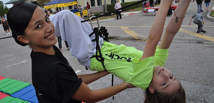 Lakewood Ranch High School JROTC student Sarely Gutierrez helped Kristina Tripoli, 9, with a rope challenge.