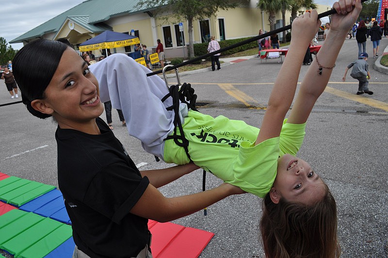 Lakewood Ranch High School JROTC student Sarely Gutierrez helped Kristina Tripoli, 9, with a rope challenge.