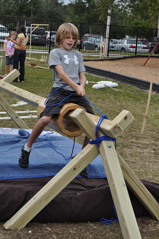 Sterling Watnem, 11, pulled himself across the pole using a rope.