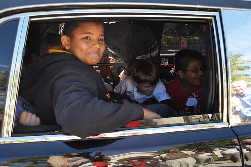 Jamez White, 11, was one of 25 boys from Moody Elementary School who got to ride a limousine around the Rosedale community today.