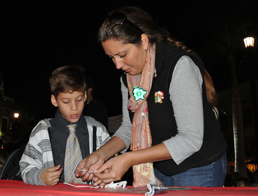 McNeal Elementary second-grader Timmy Malkoch got some help making his Santa ornament from his mom Terri.