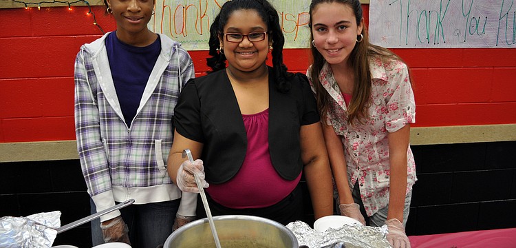 Precious Modupe, 14, Amelia Rupan, 13, and Abrielle Leeder, 12, served bowls of soup to guests.