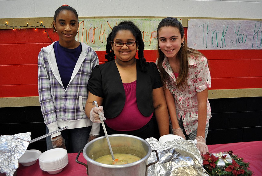Precious Modupe, 14, Amelia Rupan, 13, and Abrielle Leeder, 12, served bowls of soup to guests.