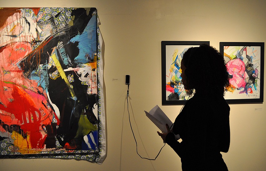 Indiana Martinez listens and looks at a piece done by Tim Jaeger.