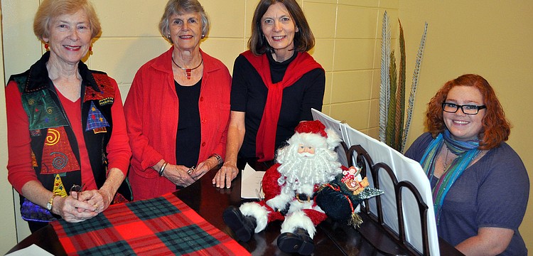 Linda Pendray, Debbie Harvey, Peg Davant and Lily Wohl pose around the piano.