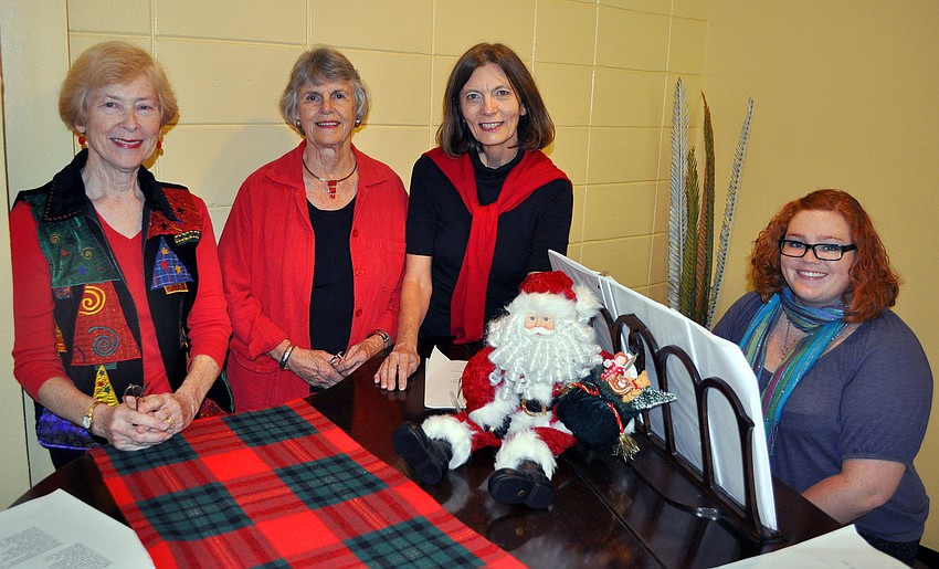 Linda Pendray, Debbie Harvey, Peg Davant and Lily Wohl pose around the piano.