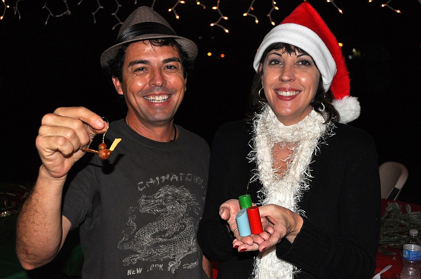 Tony Almengual and Katherine Orenic show off some ornaments they planned to hang on the Laurel Park Christmas tree, Sunday, Dec. 11, during the Laurel Park Holiday Party at Laurel Park.