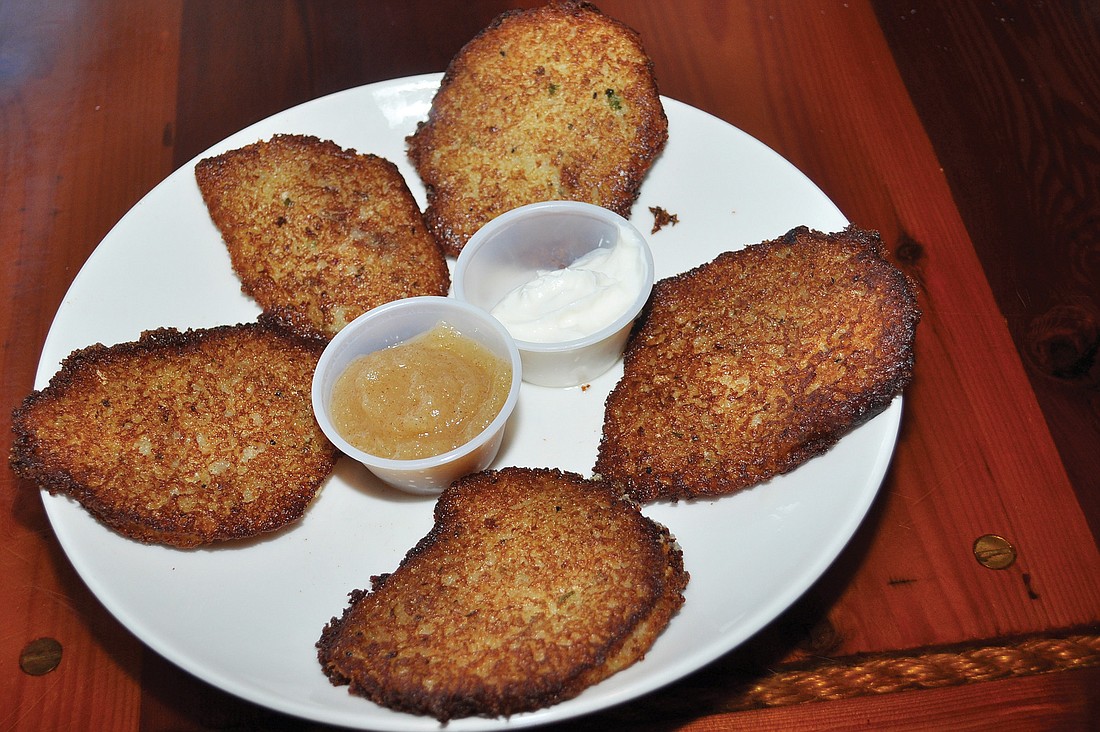 Potato latkes as served at Jimmy's Sandtrap Restaurant. These are made with a combination of finely chopped and grated potatoes at a ratio of one onion to two potatoes.