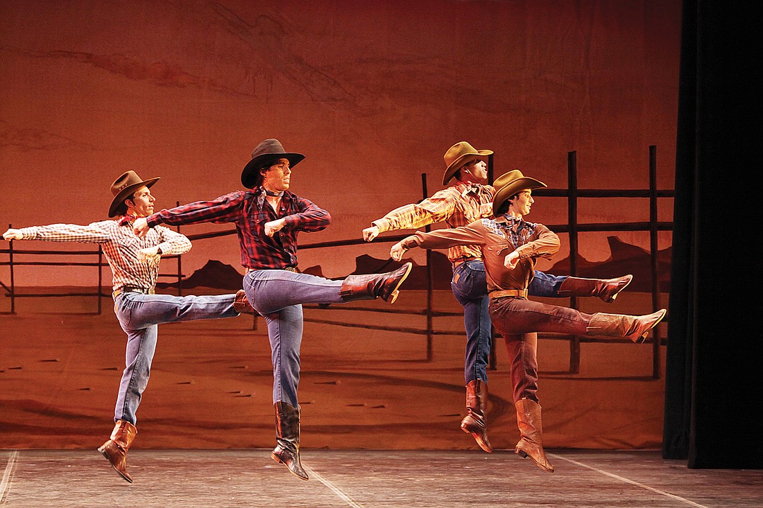 Principals Octavio Martin, second from left, and Logan Learned, fourth, lead the Cow-Hands as they kick up their boots in Agnes DeMille's "Rodeo."