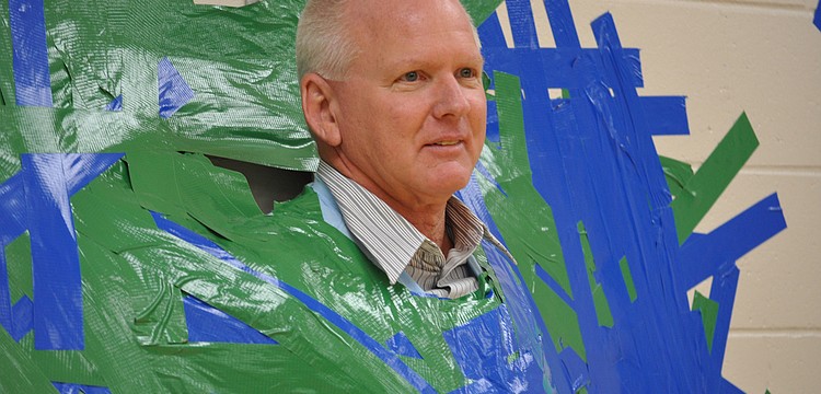 Twenty-one pounds of duct tape held Willis Elementary School Principal Bill Stenger to the wall Tuesday, Dec. 13, during a special event rewarding students for raising more than $45,000 for the school.