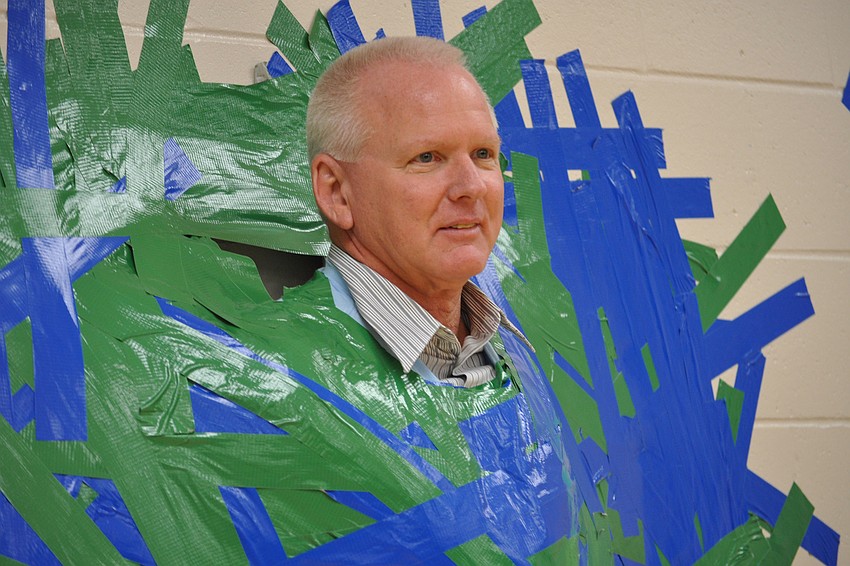 Twenty-one pounds of duct tape held Willis Elementary School Principal Bill Stenger to the wall Tuesday, Dec. 13, during a special event rewarding students for raising more than $45,000 for the school.