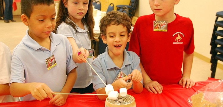 Devan Rojas, left, Hayley Dragon, Chris Maddiesquivel and Keaton Bruder enjoyed making s'mores.