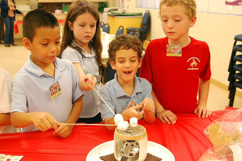 Devan Rojas, left, Hayley Dragon, Chris Maddiesquivel and Keaton Bruder enjoyed making s'mores.