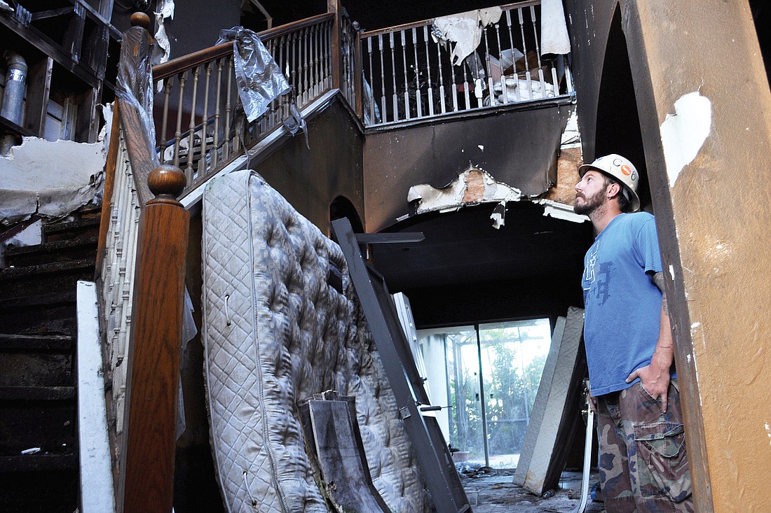 Forristall Enterprises foreman Alex Barrow checks out the inside of the home before starting its demolition Nov. 21.
