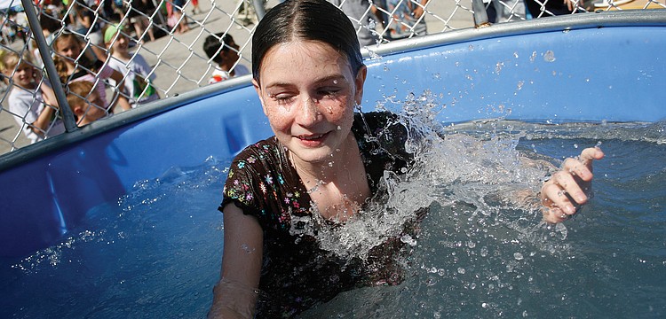 Cate Eschmann, 12, didn't mind getting wet in the dunk tank at McNeal Elementary's Winter Carnival. Published March 3, 2011.