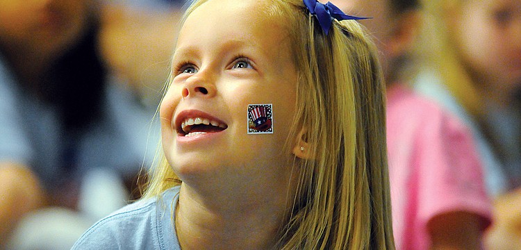 Four-year-old Jordyn Jomisko couldn't wait to show off her patriotic sticker during Freedom Elementary School's Let Freedom Ring Courtyard Ceremony Nov. 10. Published Nov. 17, 2011.
