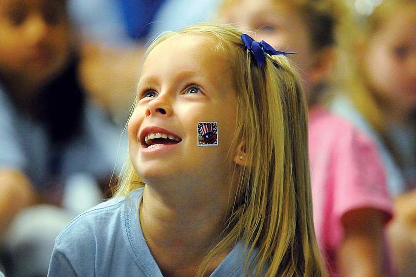 Four-year-old Jordyn Jomisko couldn't wait to show off her patriotic sticker during Freedom Elementary School's Let Freedom Ring Courtyard Ceremony Nov. 10. Published Nov. 17, 2011.
