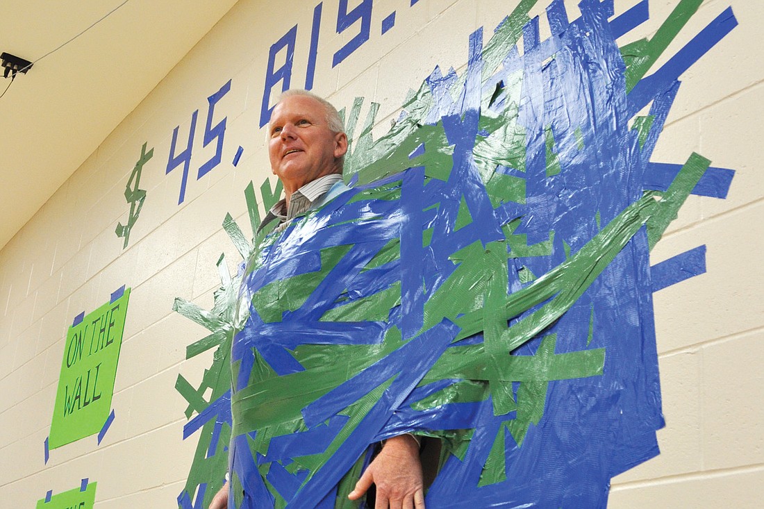 More than 1,200 pieces of duct tape held Principal Bill Stenger to the wall.