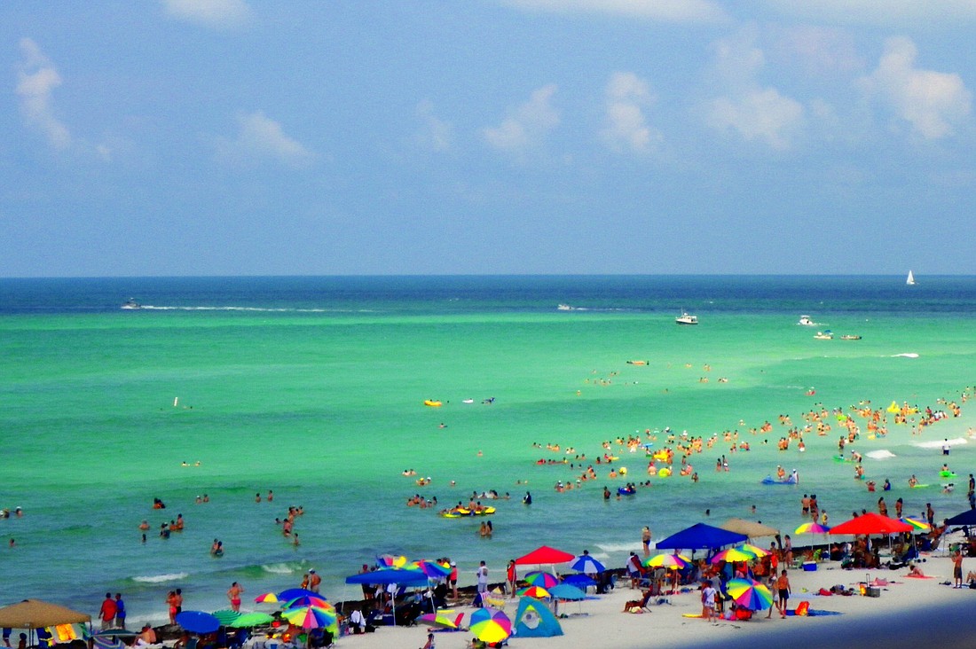 Siesta Beach with lots of folks in the water. Photo by Carolyn Bistline