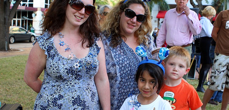 Lisa Dubow, Alice Dubow, 6, Teresa Outwaite and Max Outwaite, 6, wore some festive Chanukah headbands and necklaces at A Taste of Chanukah, Tuesday, Dec. 20 at Five Points Park.