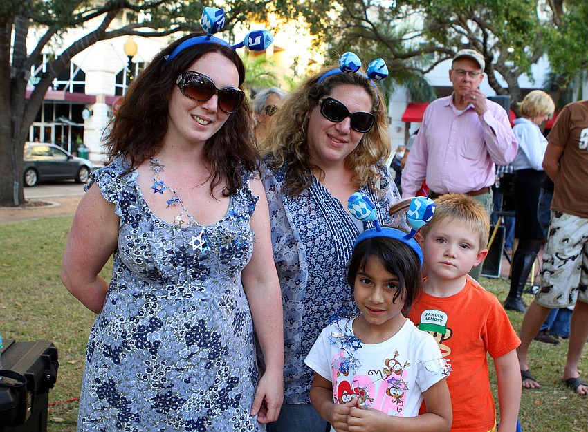 Lisa Dubow, Alice Dubow, 6, Teresa Outwaite and Max Outwaite, 6, wore some festive Chanukah headbands and necklaces at A Taste of Chanukah, Tuesday, Dec. 20 at Five Points Park.