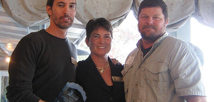 Siesta Key Chamber of Commerce President Cheryl Gaddie presented Russell Matthes and Troy Syprett, co-owners of the Daiquiri Deck, the award for Large Business of the Year.