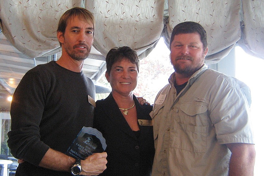 Siesta Key Chamber of Commerce President Cheryl Gaddie presented Russell Matthes and Troy Syprett, co-owners of the Daiquiri Deck, the award for Large Business of the Year.